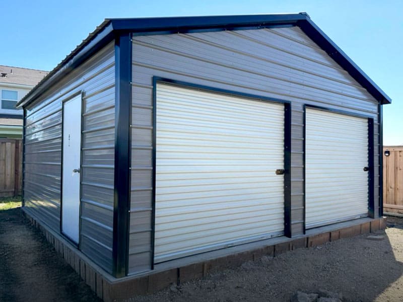 A 2-car metal garage installed on a perfectly poured concrete pad